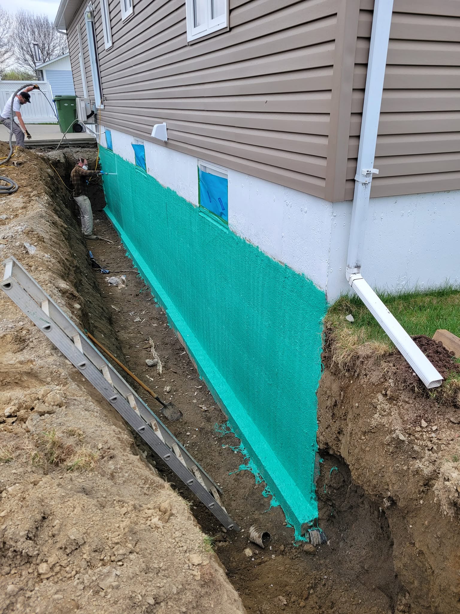 Spray waterproofing on foundation wall